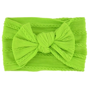 Detail of neon green jacquard nylon baby headband with a soft oversized bow decoration