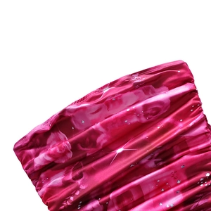 Detail of fuchsia pleated tube dress with floral patterns and sparkling glitter details