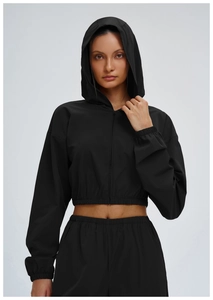Close-up of lightweight black windproof hooded sports jacket with elastic cuffs and hem