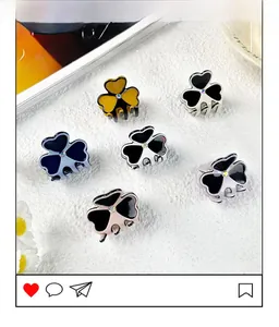 Set of six mini acetate clover hair clips with rhinestone centers in varied colors