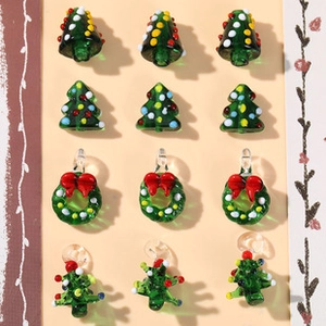 Macro view of Christmas tree and wreath glass charms for DIY jewelry making