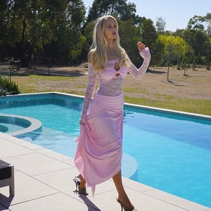 Detailed lace stitching and bow decoration on a pink off-shoulder summer dress