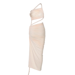 Close-up of the light apricot ruched dress featuring cut-out waist and rope details