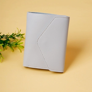 Detail of light grey tri-fold mini wallet showing pebbled texture and envelope flap design