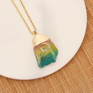 Gold rope chain necklace with a rainbow raw crystal pendant featuring a crescent moon and star