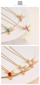 Detailed macro view of colorful hummingbird pendants with vibrant crystals and gold plating