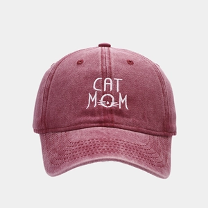 Detail of washed burgundy cotton baseball cap featuring CAT MOM embroidery and cat whiskers
