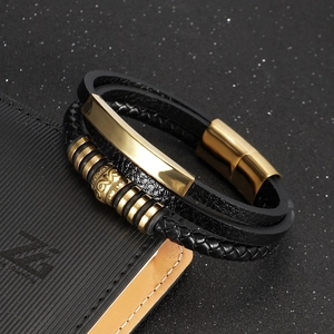 Men's multi-layer black braided leather bracelet with golden magnetic clasp on black surface