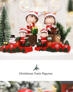 Close-up of Christmas resin figurines featuring a red train, snowman and elk decorations