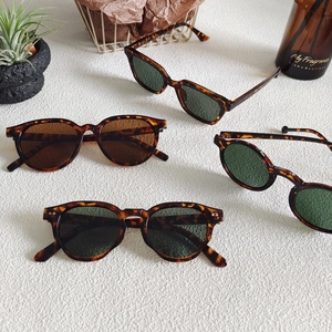 Detailed display of leopard print sunglasses in various retro frames and dark lenses