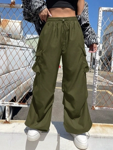 Detail of olive green cargo pants featuring large side pockets and baggy wide-leg fit