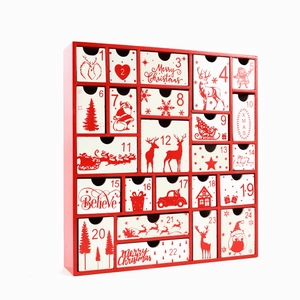 Detail of red wooden 24-drawer Christmas advent calendar box with festive holiday patterns