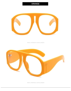 Detail view of bold orange flat-top sunglasses with thick frames and oversized design