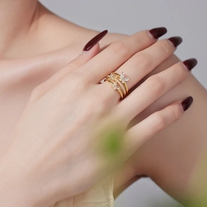 Detailed view of the layered gold butterfly ring featuring sparkling white crystal inlay