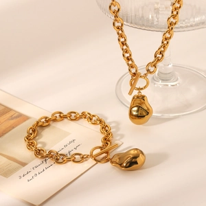 Titanium steel jewelry set with OT buckle and irregular lava pendants in gold finish