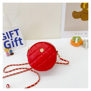 Detail of red quilted round crossbody bag with golden camellia flower and chain strap