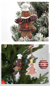Detailed Christmas gingerbread man and festive tree hanging ornaments on a pine branch