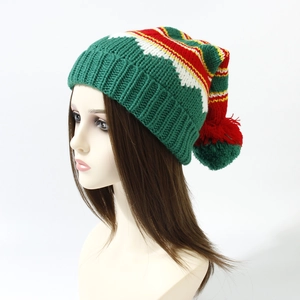 Detail view of knitted Christmas hat with pompom and striped snowflake patterns