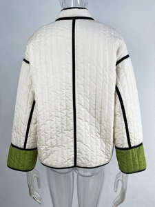 Detailed back view of a quilted jacket with contrast piping and green stitching details