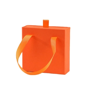 Vibrant orange jewelry drawer box with ribbon handle and pull tab for necklaces