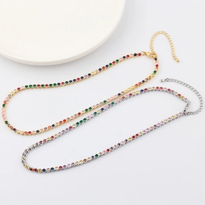 Detail of gold and silver necklaces with colorful crystals and lobster clasp closure