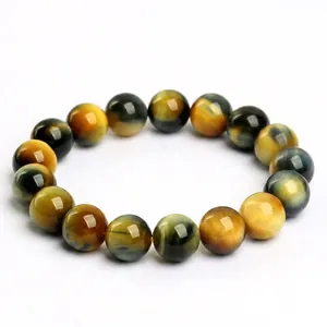 Natural yellow and blue tiger eye stone bead bracelet with cat eye effect on white background