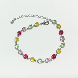Colorful zircon tennis bracelet with red, yellow, green, and pink stones in a minimalist design