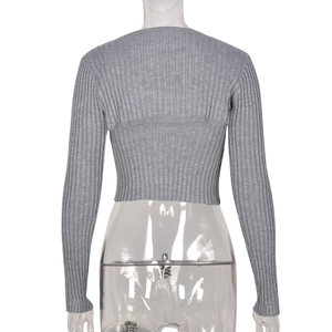 Back view of a cropped light gray knit cardigan with vertical ribbed texture on a model