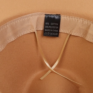 Detail of the inner lining of the camel hat showing the adjustable drawstring and material label