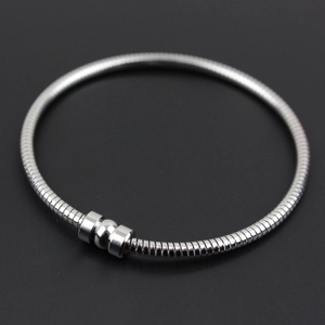 Sleek 304 stainless steel snake chain bangle with round magnetic clasp on dark background
