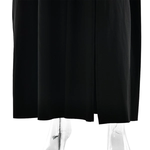 Detail view of the elegant black pleated dress hem with fluid drapery and ribbon design