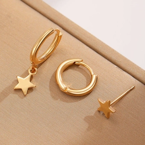 Three-piece gold plated star earring set featuring small hoops and a stud on brown box