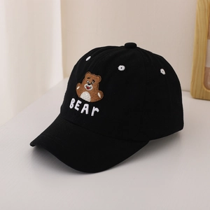 Detail of embroidered brown bear and BEAR text on a black kids cotton baseball cap