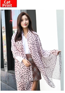 Detail of thin pale pink chiffon scarf with black cat silhouette print texture