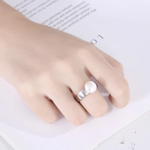 French minimalist stainless steel ring with a large white pearl on a matte silver band