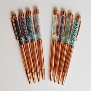 Set of 8 rose gold ballpoint pens filled with colorful crystal crushed stones on white