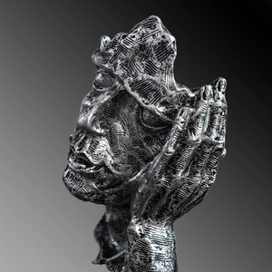 Abstract silver Nordic sculpture featuring a face and hand with artistic textured finish