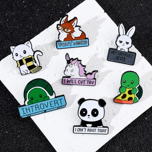 Detailed overhead shot of colorful enamel animal pins featuring a panda fox and turtle