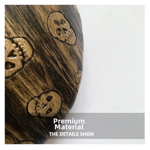 Close-up detail of dark wood grain texture with embossed skull pattern on leather accessory