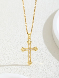 Macro detail of a vintage gold cross pendant with shimmering white zircon inlay on O-chain