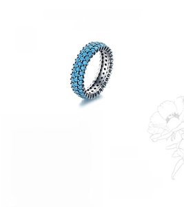 Macro detail of S925 sterling silver ring featuring claw-set turquoise stone accents