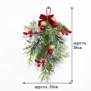 Detail of Christmas teardrop swag with pine needles, red berries and velvet bow decoration