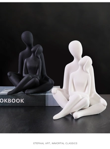 Macro detail of matte ceramic couple sculptures in black and white minimalist art style
