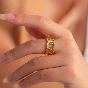 Macro detail of gold plated stainless steel ring with vintage chain link texture