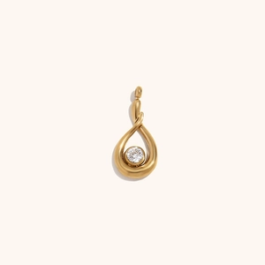 Minimalist 18K gold plated teardrop pendant with clear zircon stone on beige background