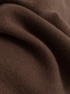 Macro detail of high-quality brown knitted fabric showing delicate texture and soft fibers