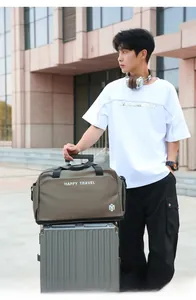 Large travel bag with Happy Travel print attached to a silver suitcase handle
