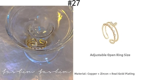 Detailed view of double-layer gold plated ring with heart and zircon accents
