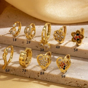 Collection of nine gold plated copper hoop earrings with CZ stone heart and snake designs