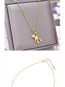 Detail of 3D bear pendant necklace featuring polished gold plating and adjustable clasp